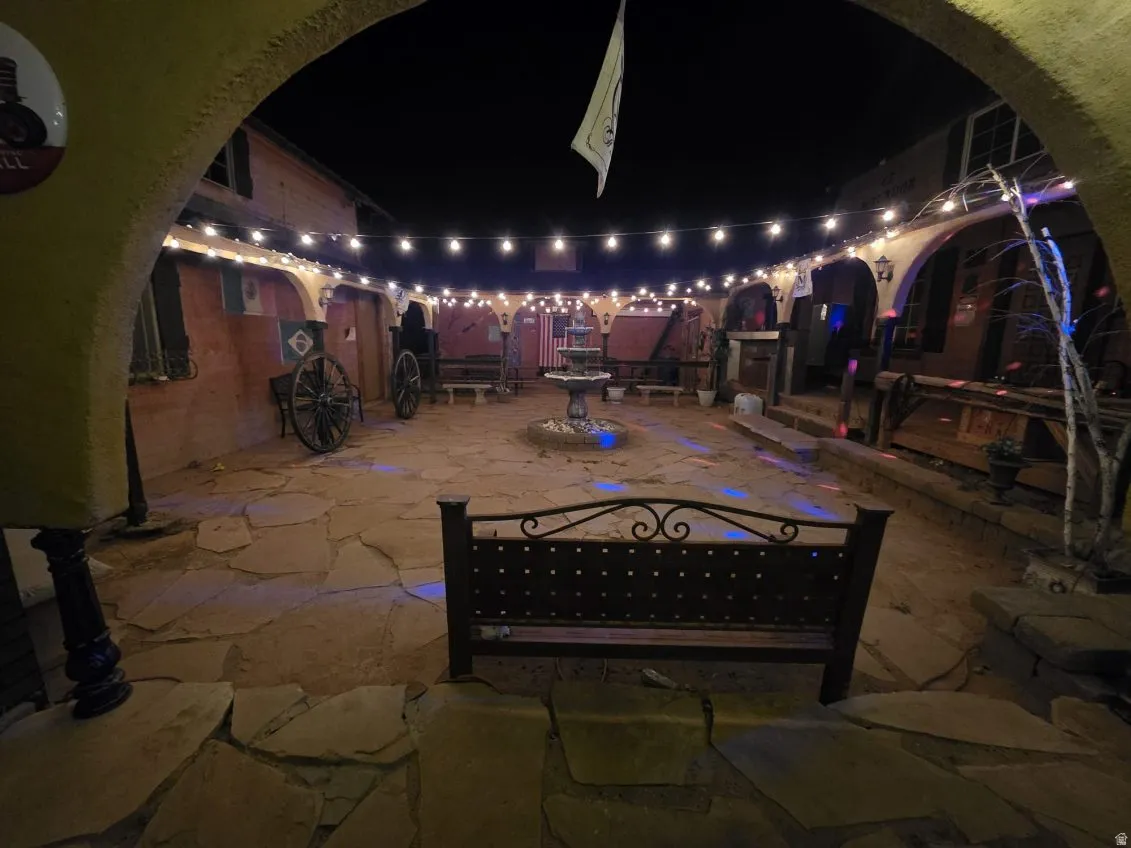 Patio at night featuring a patio area