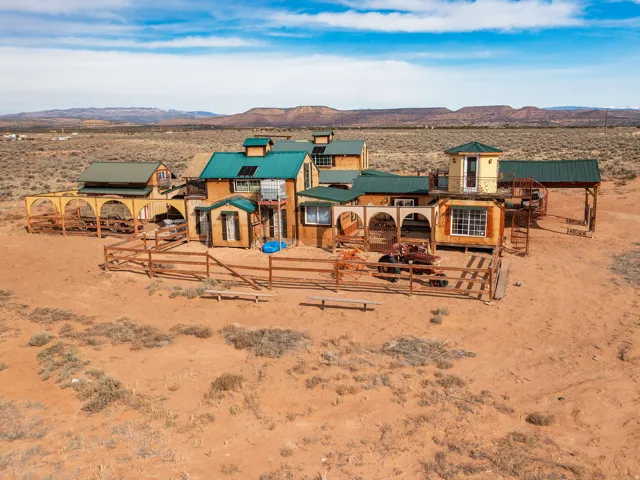 View of playground featuring a mountain view, view of desert landscape, and a patio