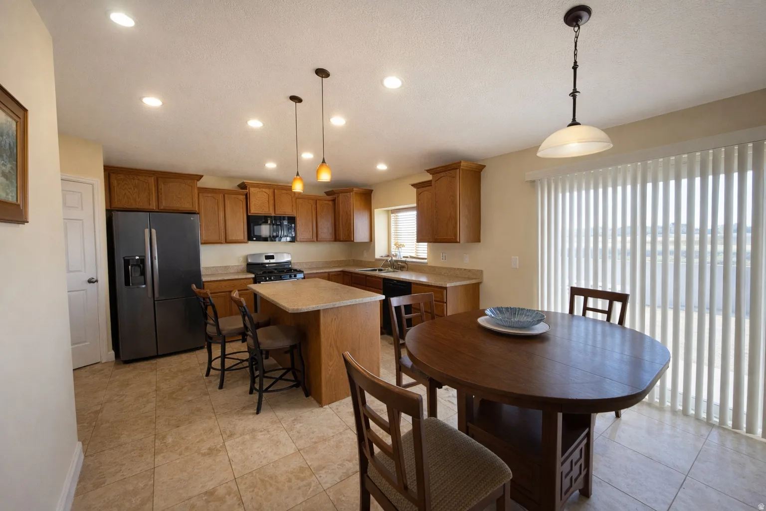 Dining space with recessed lighting and light tile patterned floors