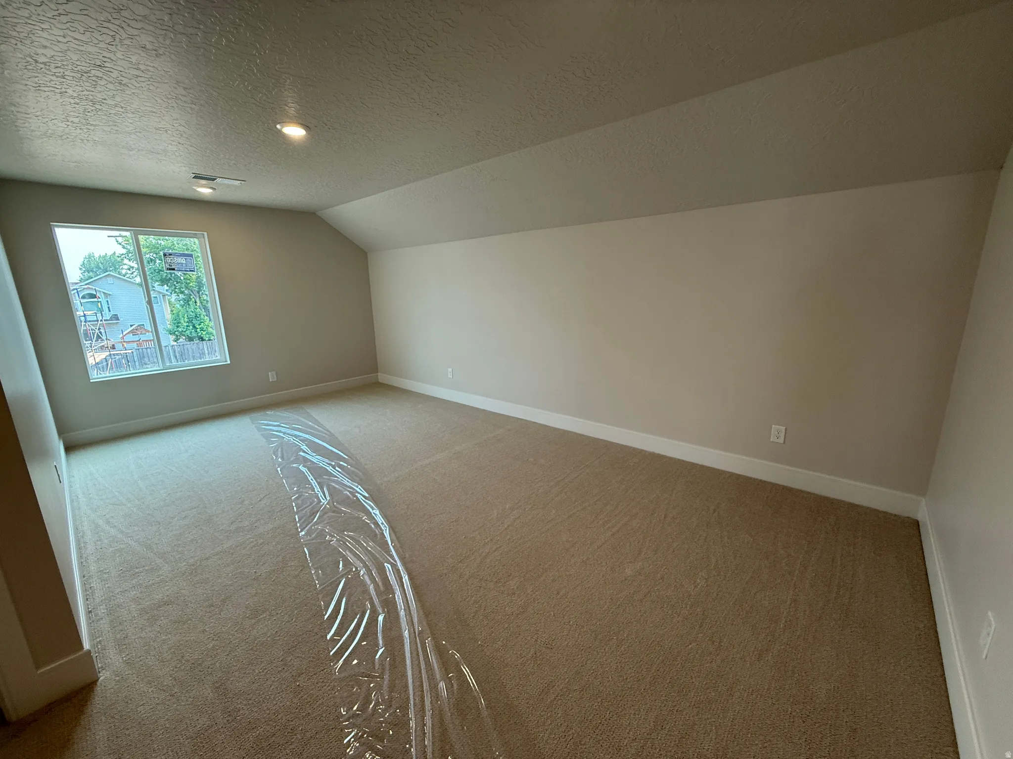 Carpeted Loft featuring a white-framed window, recessed lighting, and sloped ceiling