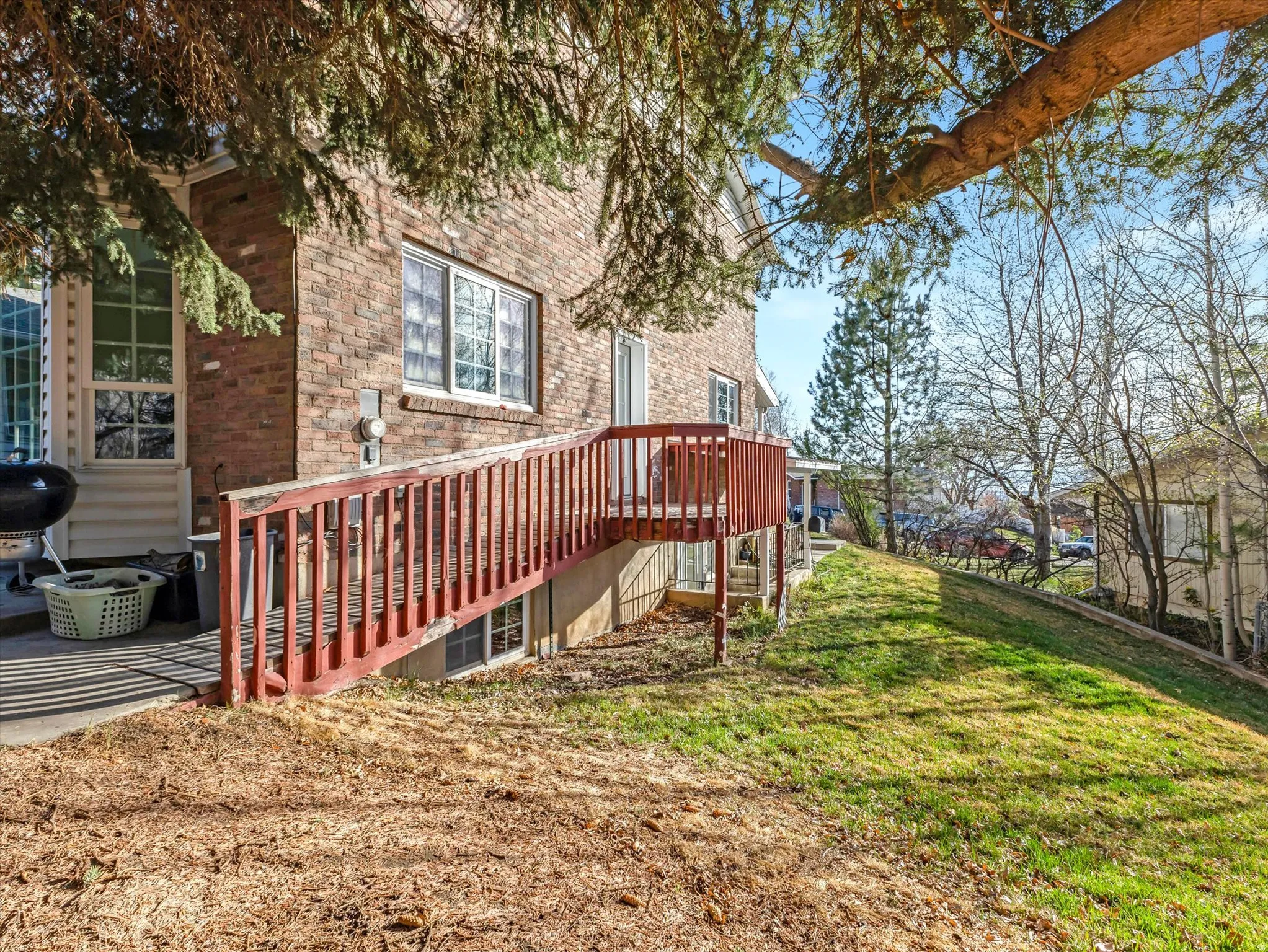 View of green lawn featuring a deck