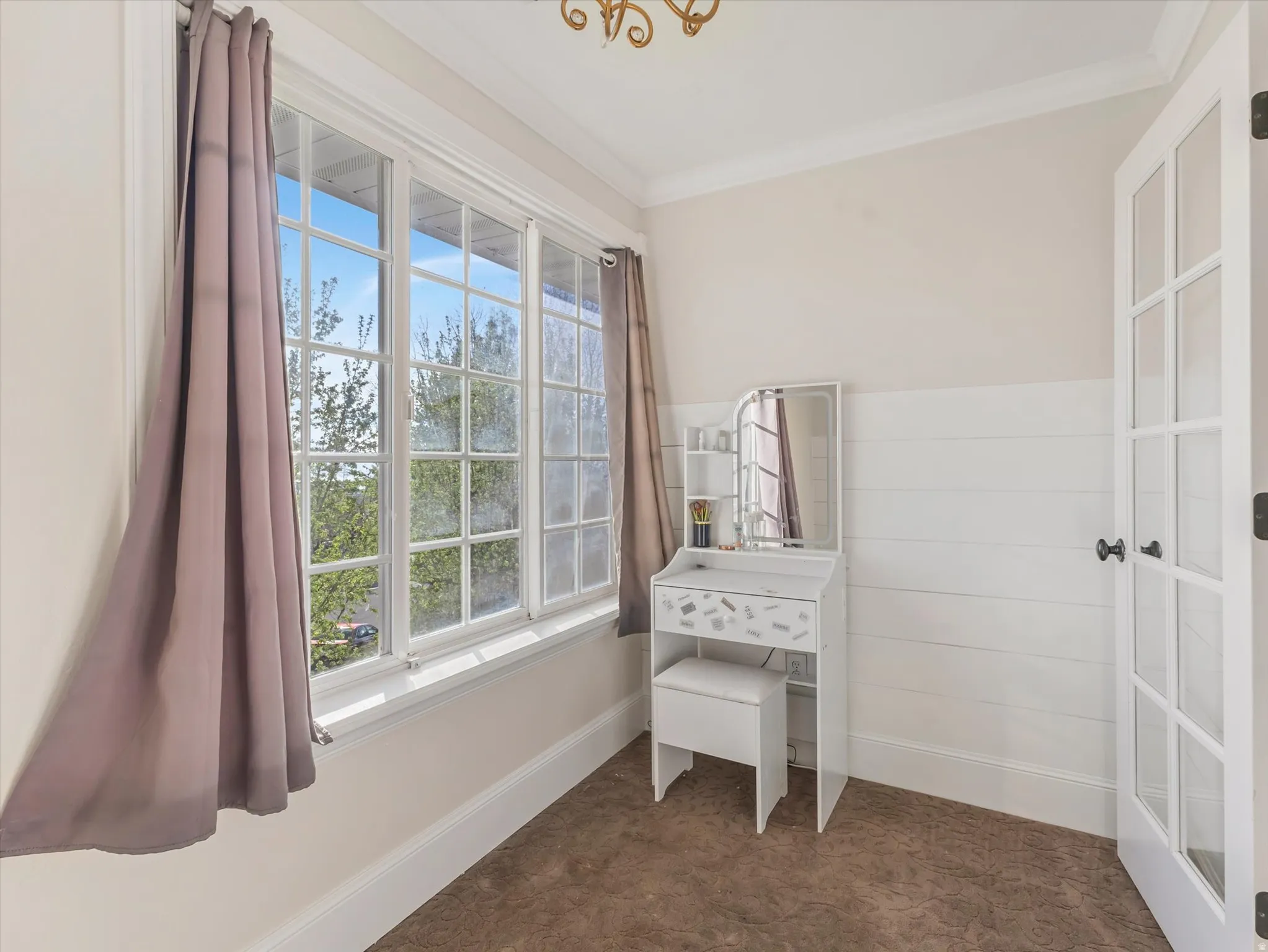 Primary bedroom with large windows.