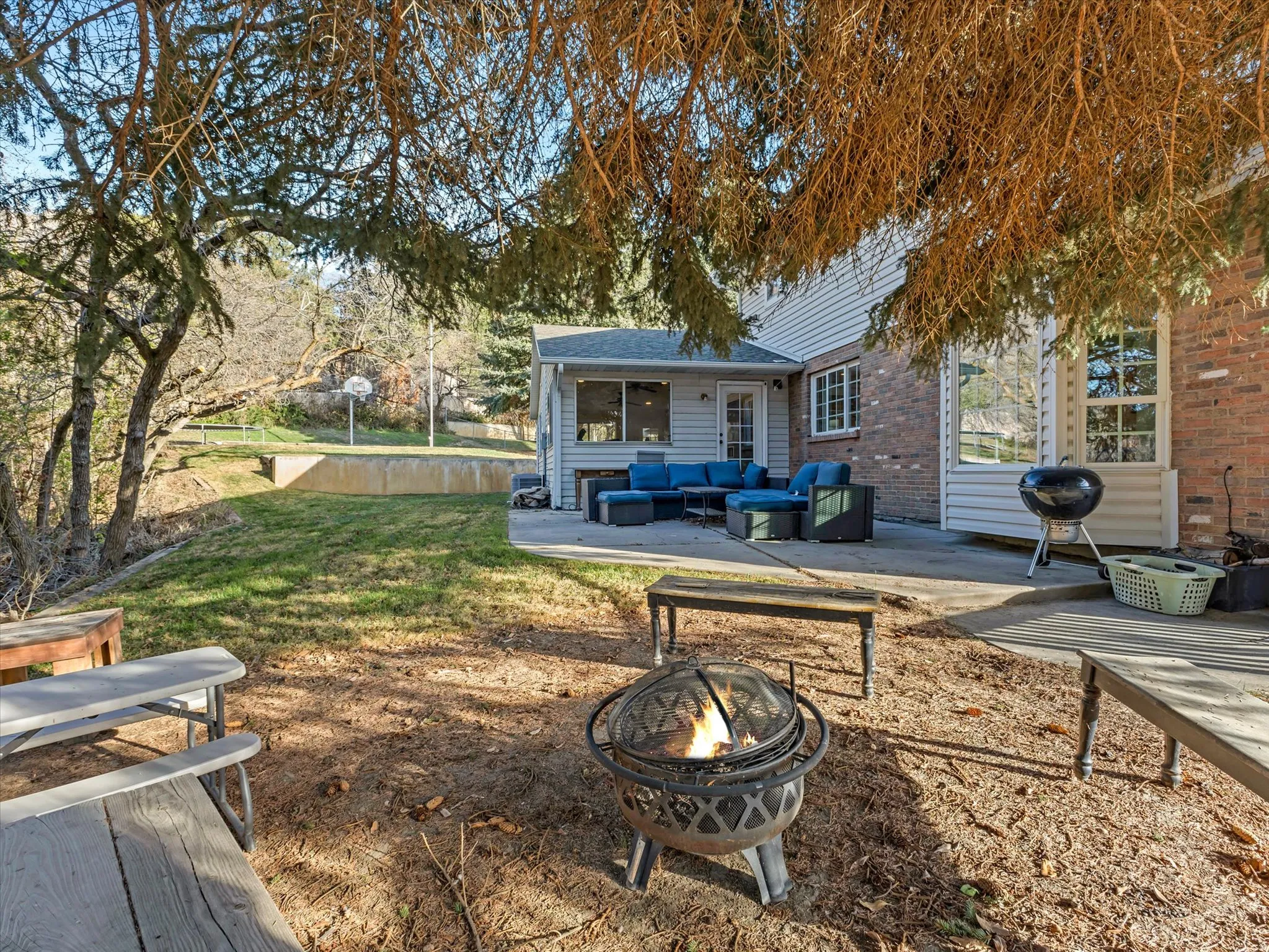View of yard featuring a patio and an outdoor living space with a fire pit