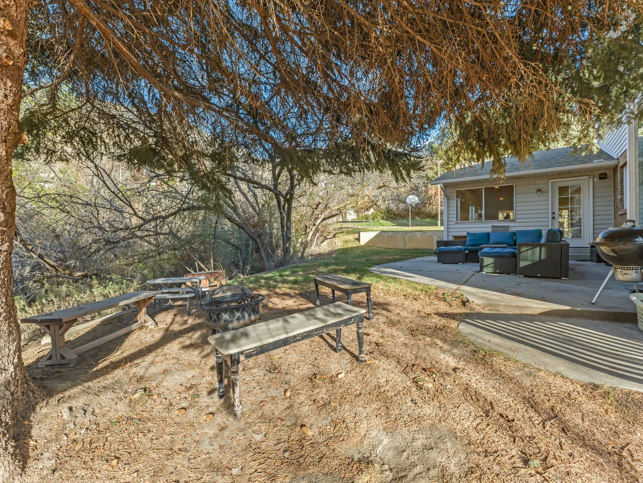 View of yard featuring an outdoor living space with a fire pit and a patio area