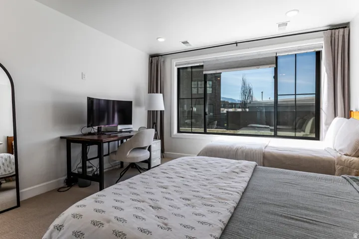 Bedroom with light carpet and baseboards