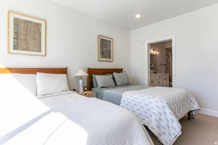 Bedroom featuring carpet floors and ensuite bath