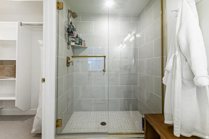 Full bathroom featuring a stall shower and a walk in closet