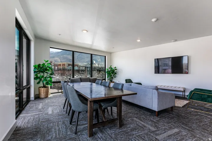 Dining space with baseboards and dark colored carpet