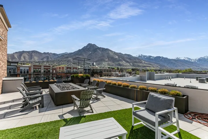View of patio with a mountain view and an outdoor fire pit