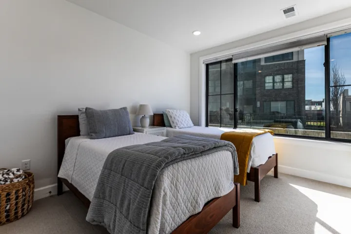 Bedroom with light carpet and recessed lighting