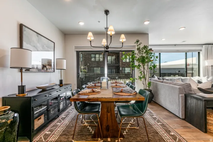 Dining room with wood finished floors and hanging lights