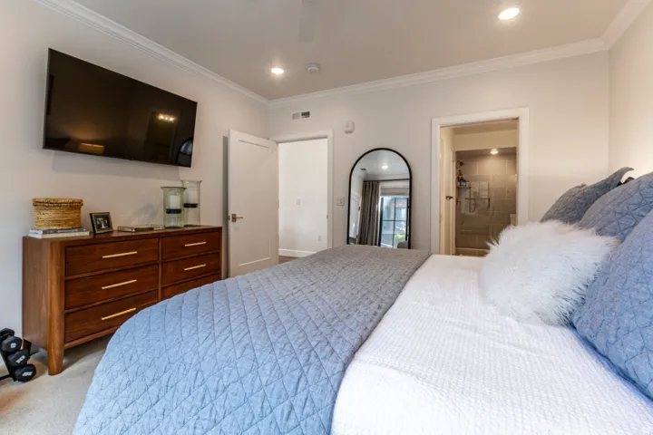 Bedroom featuring ensuite bath, ornamental molding, light carpet, recessed lighting, and ceiling fan