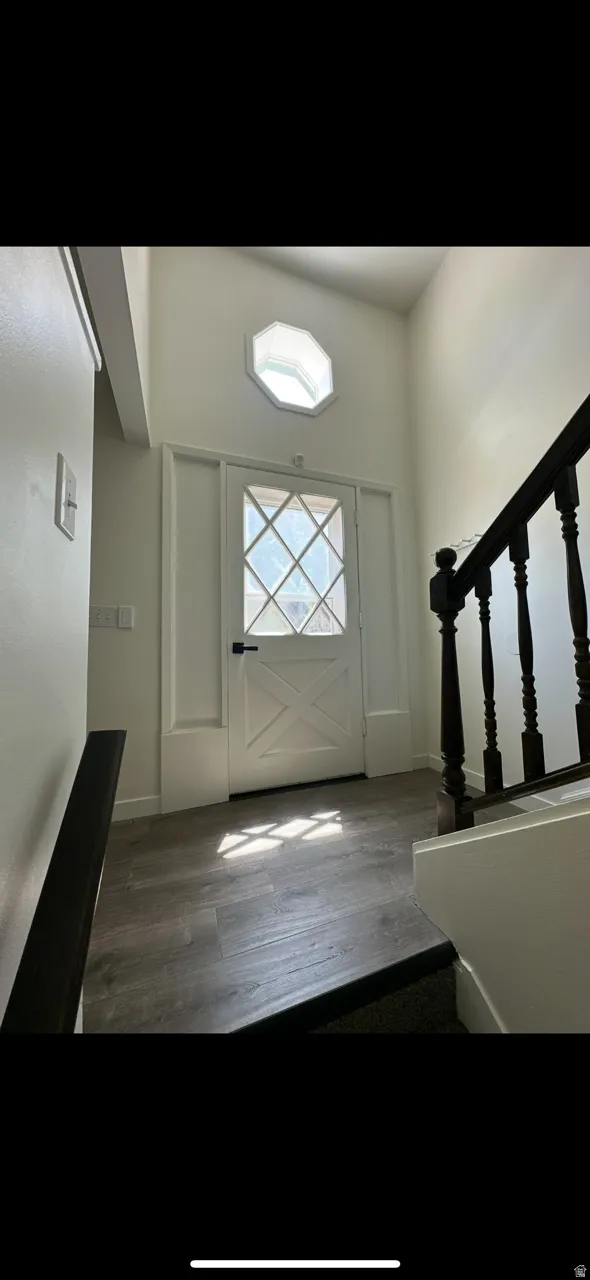 Foyer featuring stairs and dark wood finished floors