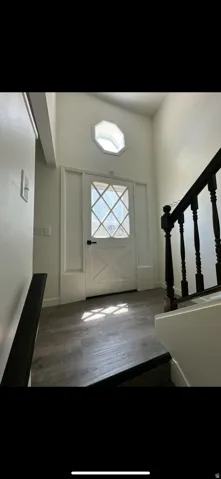 Foyer featuring stairs and dark wood finished floors