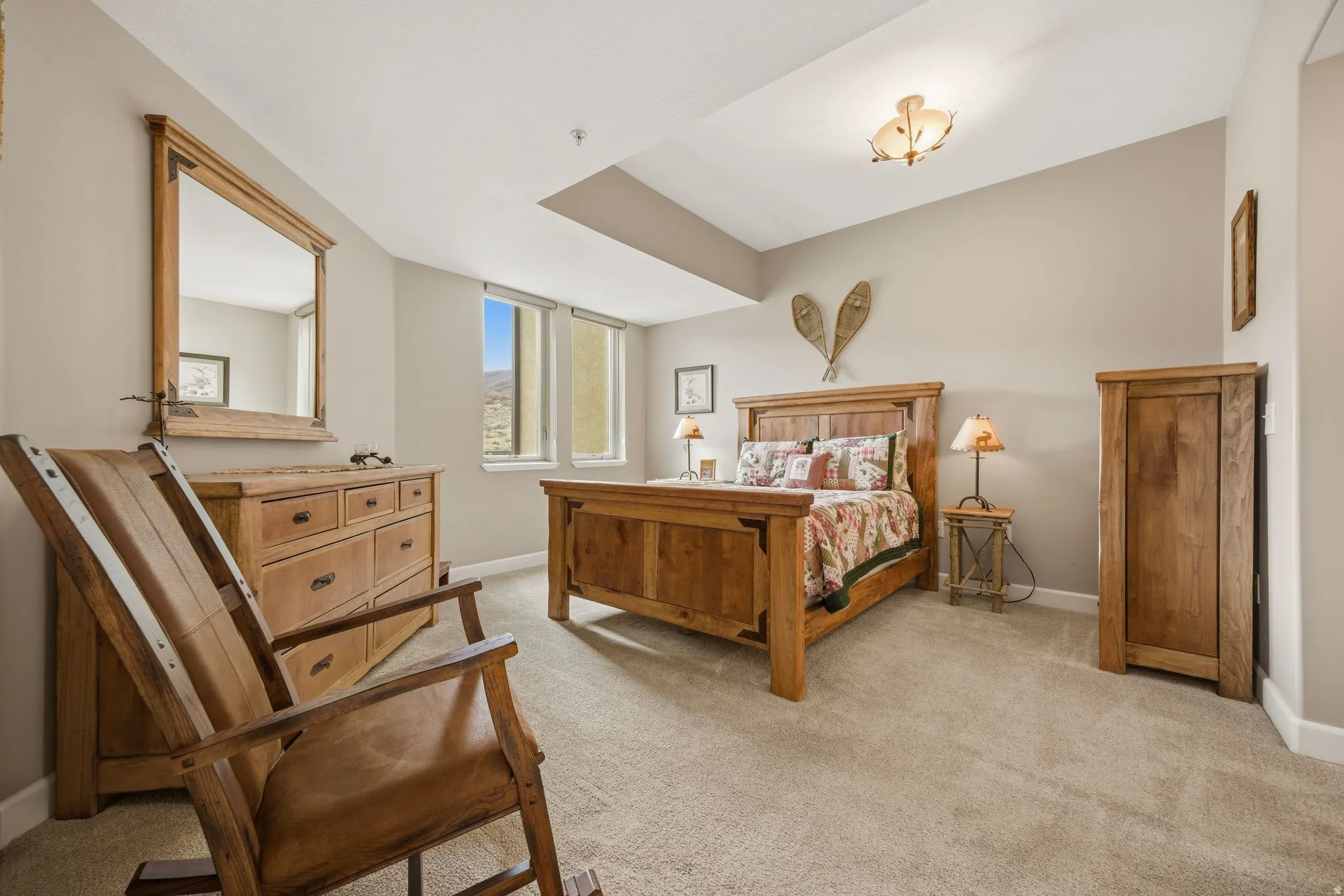 Bedroom with light colored carpet and baseboards