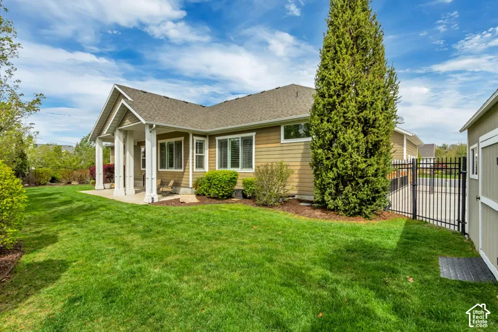 Back of property featuring a patio area and roof with shingles
