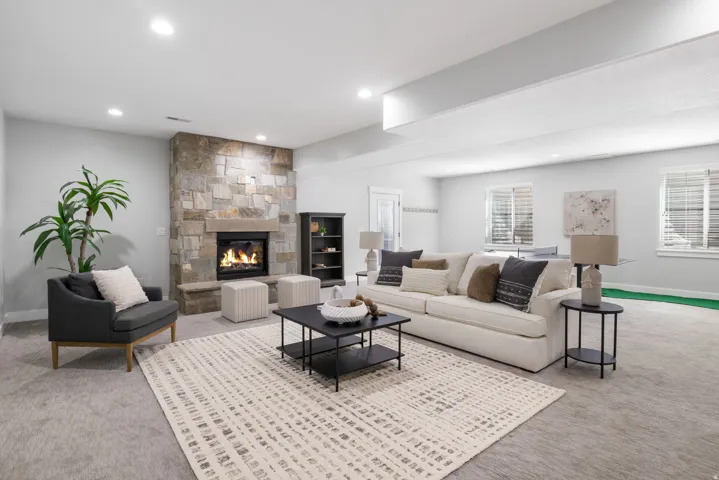 Living room featuring carpet, a fireplace, and recessed lighting