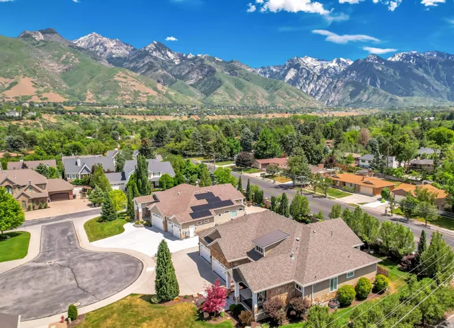 Elevated aerial panorama showcasing a residential neighborhood with mountain scenery