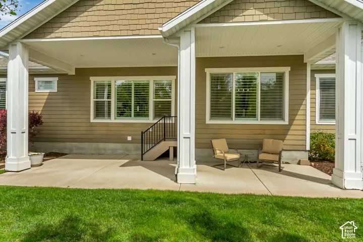 Back of house with a patio area and a yard