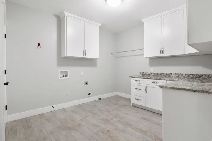 Laundry room with hookup for a gas dryer, cabinet space, hookup for a washing machine, and electric dryer hookup
