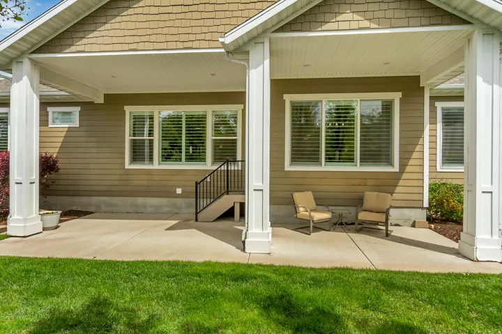 Back of house with a patio area and a yard
