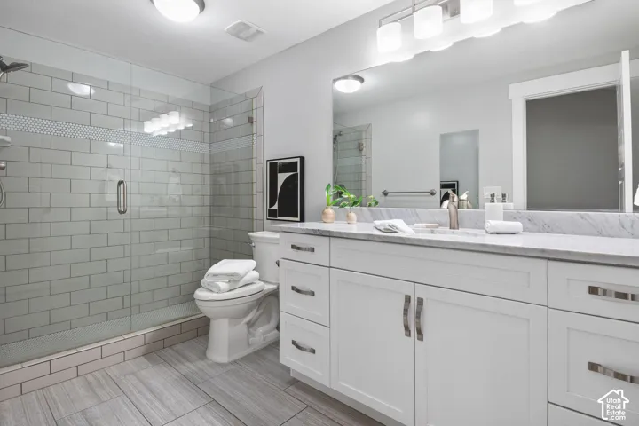 Bathroom with a shower stall and vanity