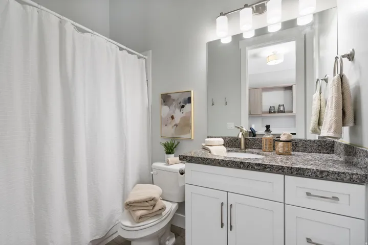 Full bath featuring a shower with shower curtain and vanity