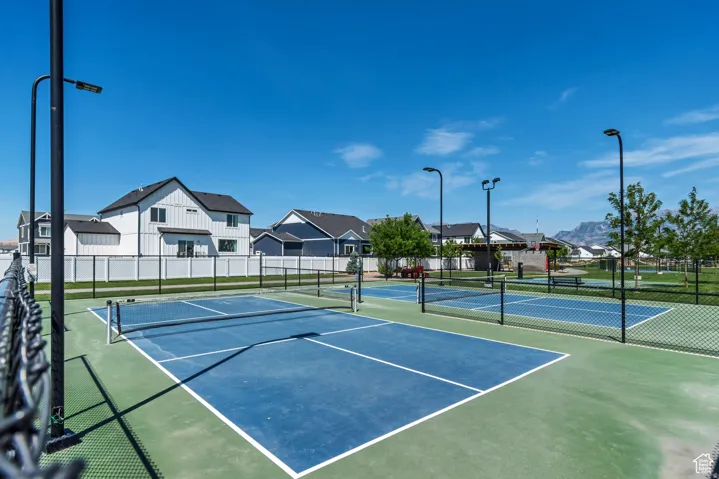 View of tennis court featuring a residential view