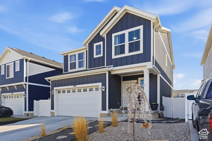 Two-story exterior with dark blue vertical siding and white trim