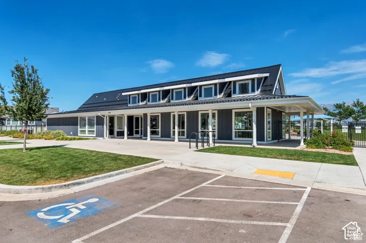 View of property featuring uncovered parking