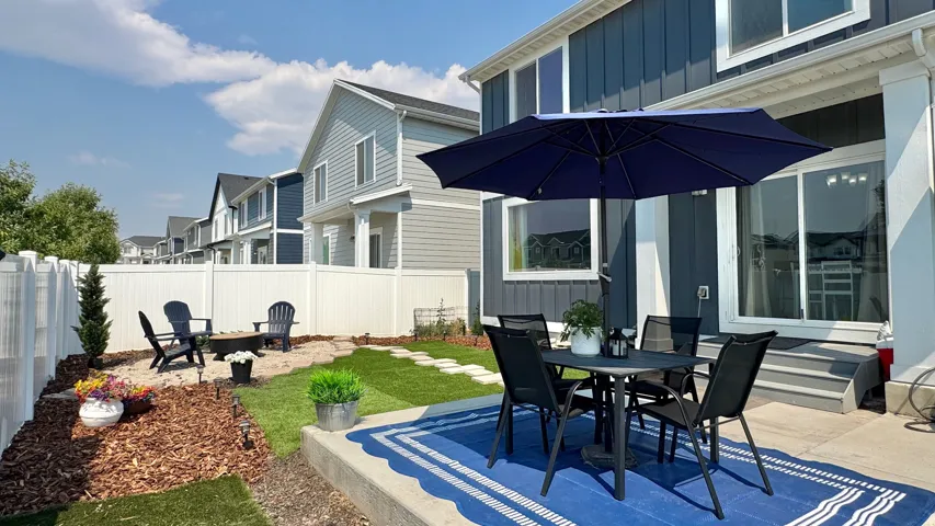 Backyard patio featuring concrete surfacing, a sliding glass door entry, and a dedicated fire pit area
