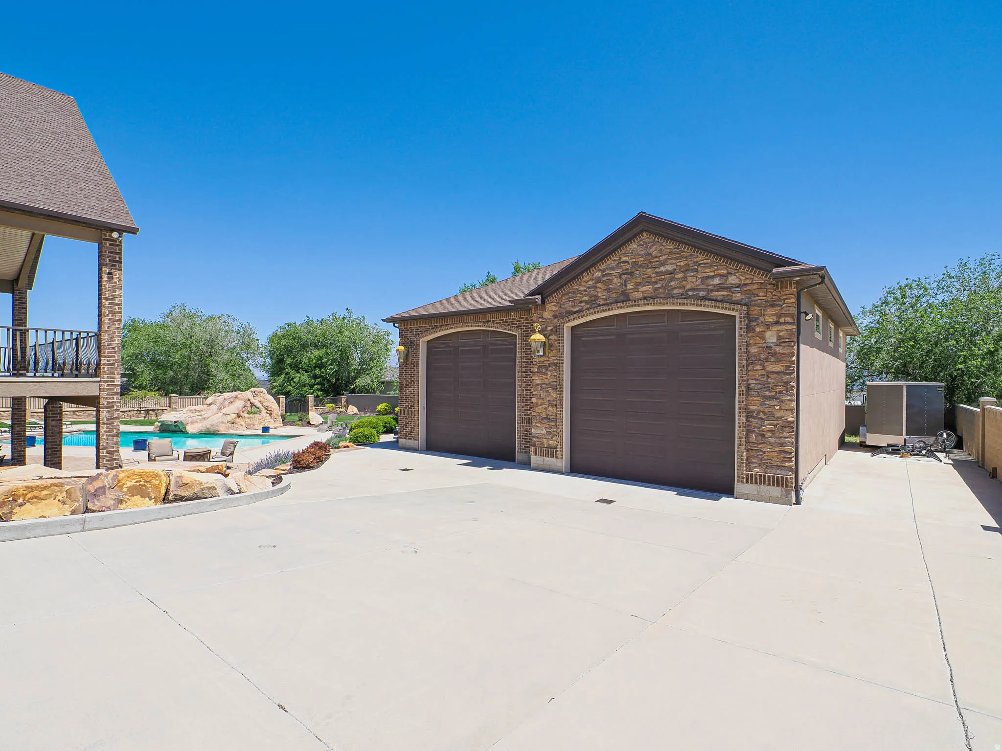 Detached two-car garage with stone fa