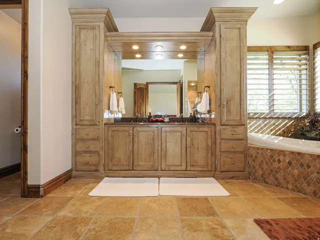 Dual vanity featuring distressed wood cabinetry with ample storage
