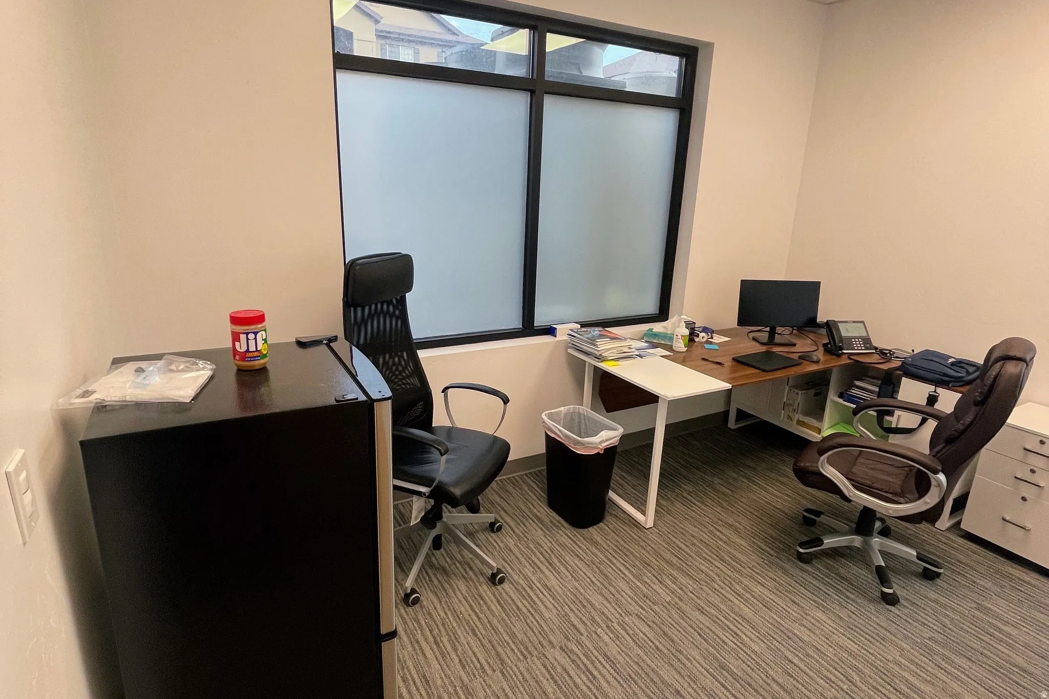 Carpeted office space with baseboards