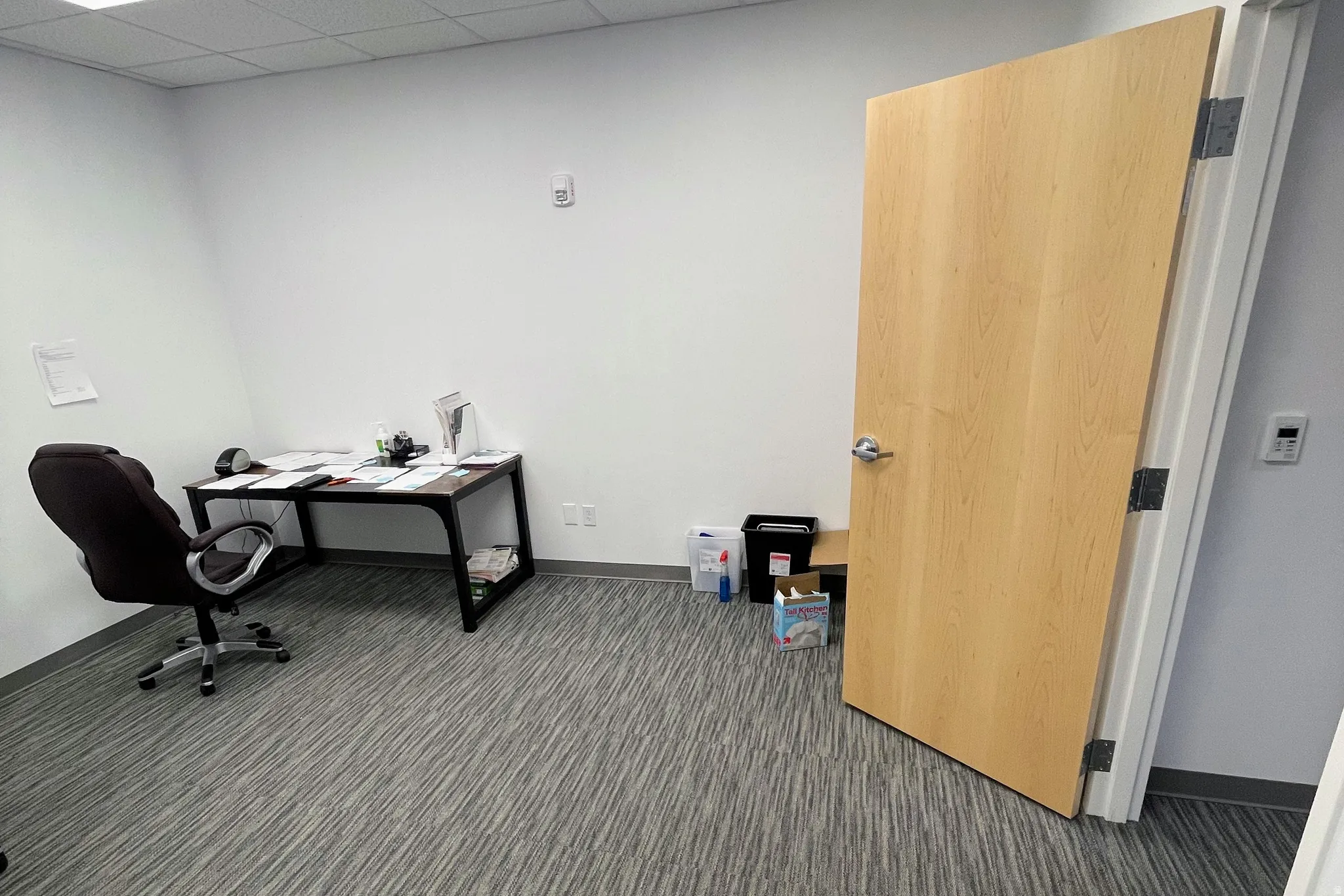 Office with dark colored carpet