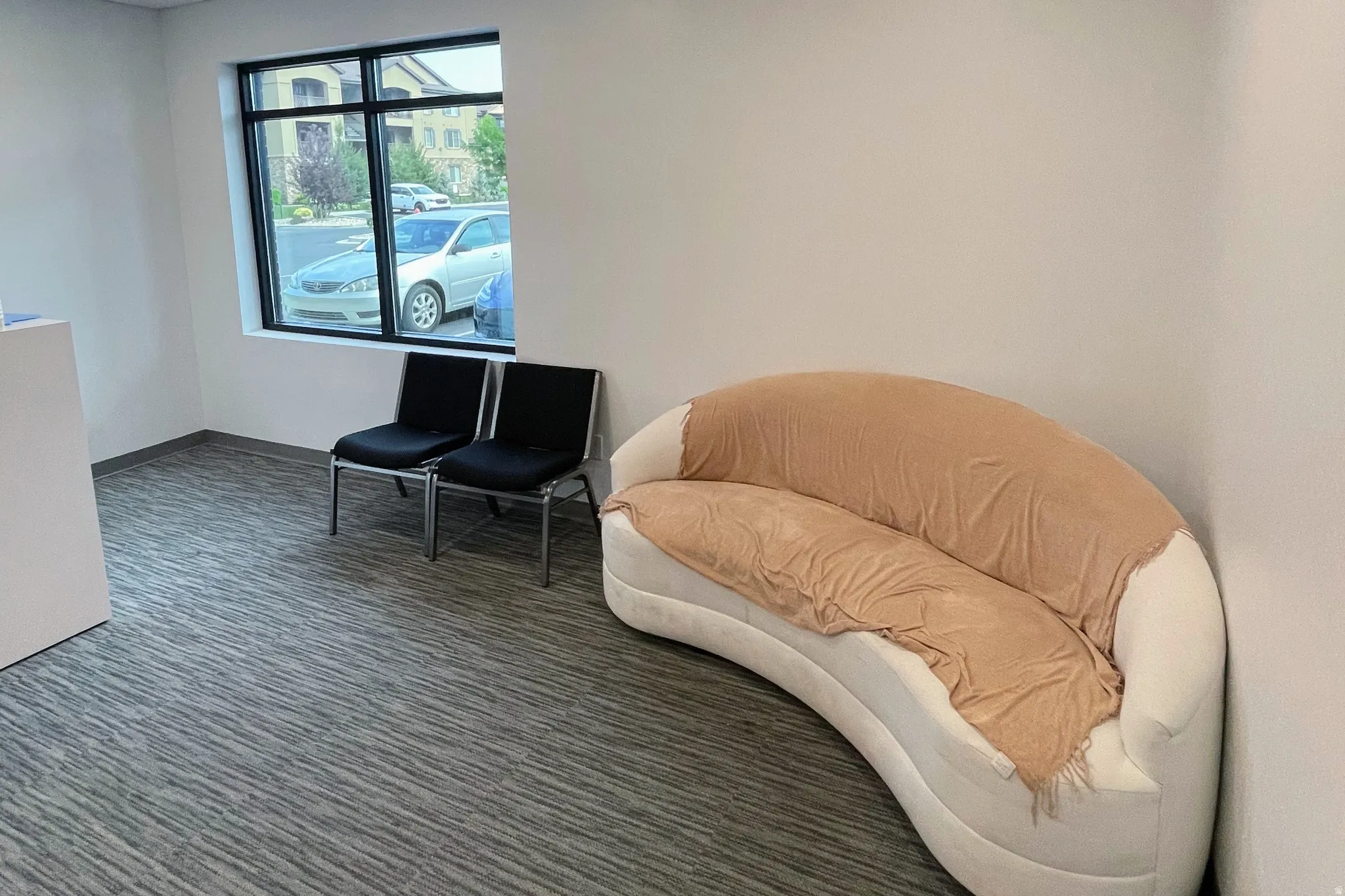 Living area with carpet flooring and baseboards