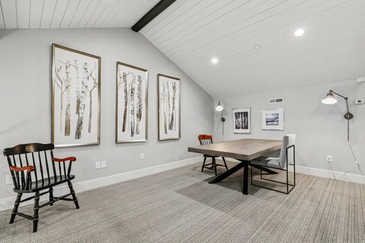 Carpeted dining area with recessed lighting and beam ceiling