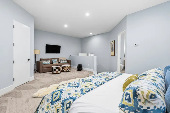 Bedroom featuring light carpet and recessed lighting