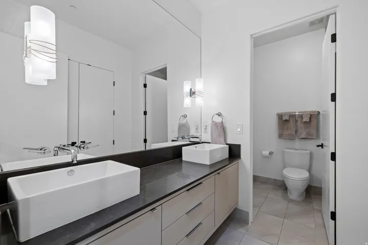 Bathroom featuring double vanity and light tile patterned floors