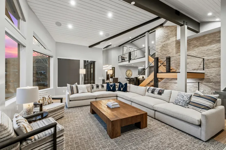 Living room with recessed lighting and an accent wall