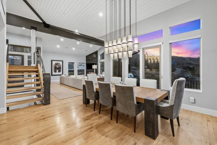 Dining area with light wood-style floors and hanging lights