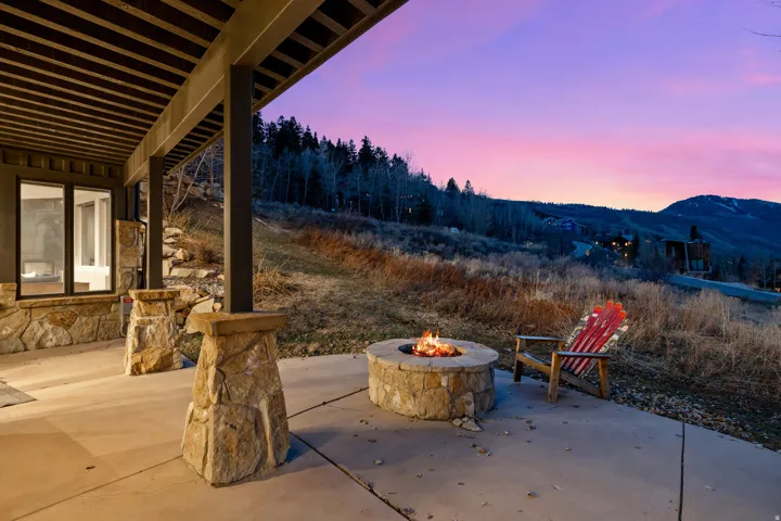 Patio terrace at dusk with a patio, an outdoor fire pit, and a mountain view