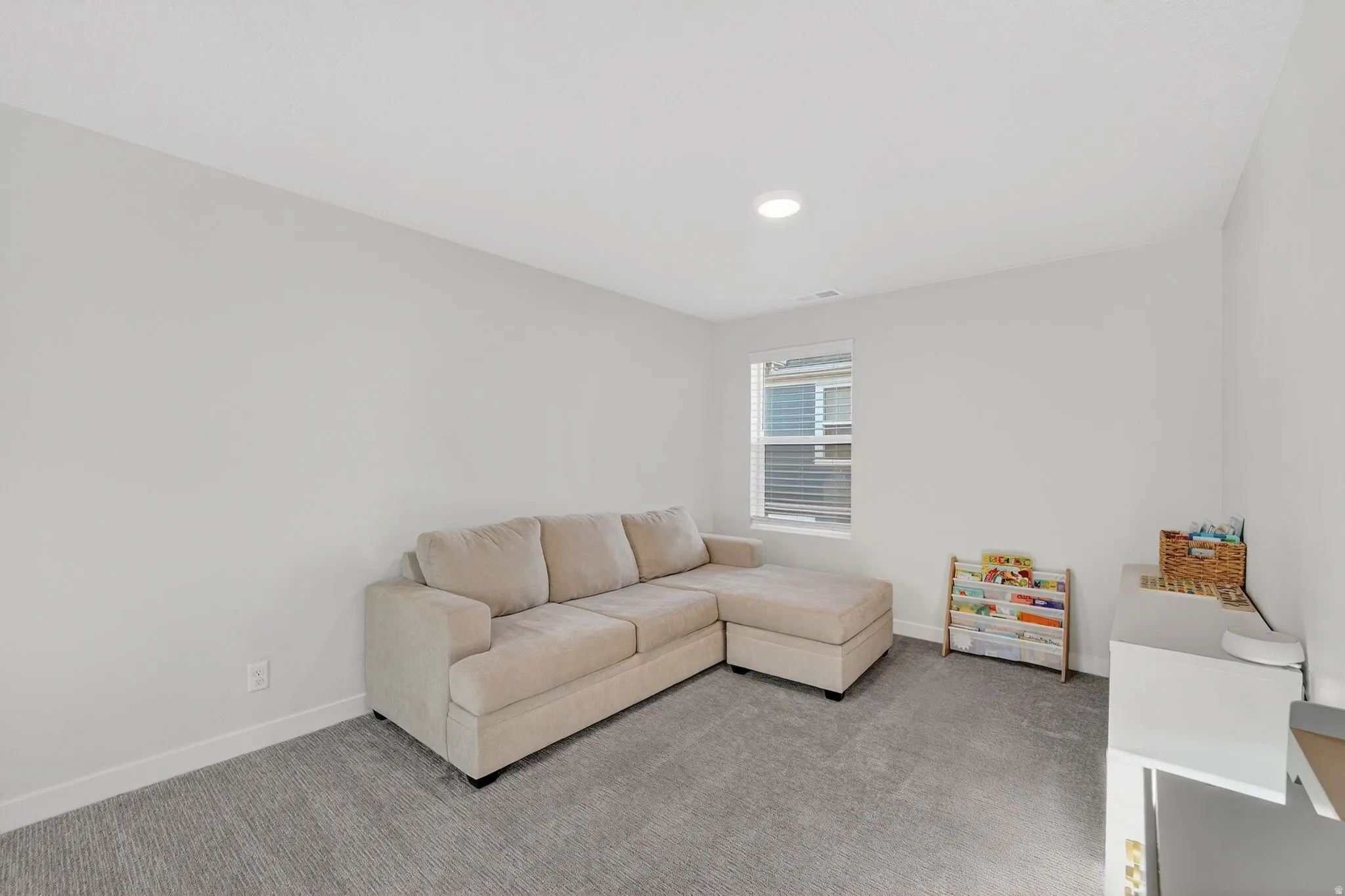 Living area with carpet floors and baseboards