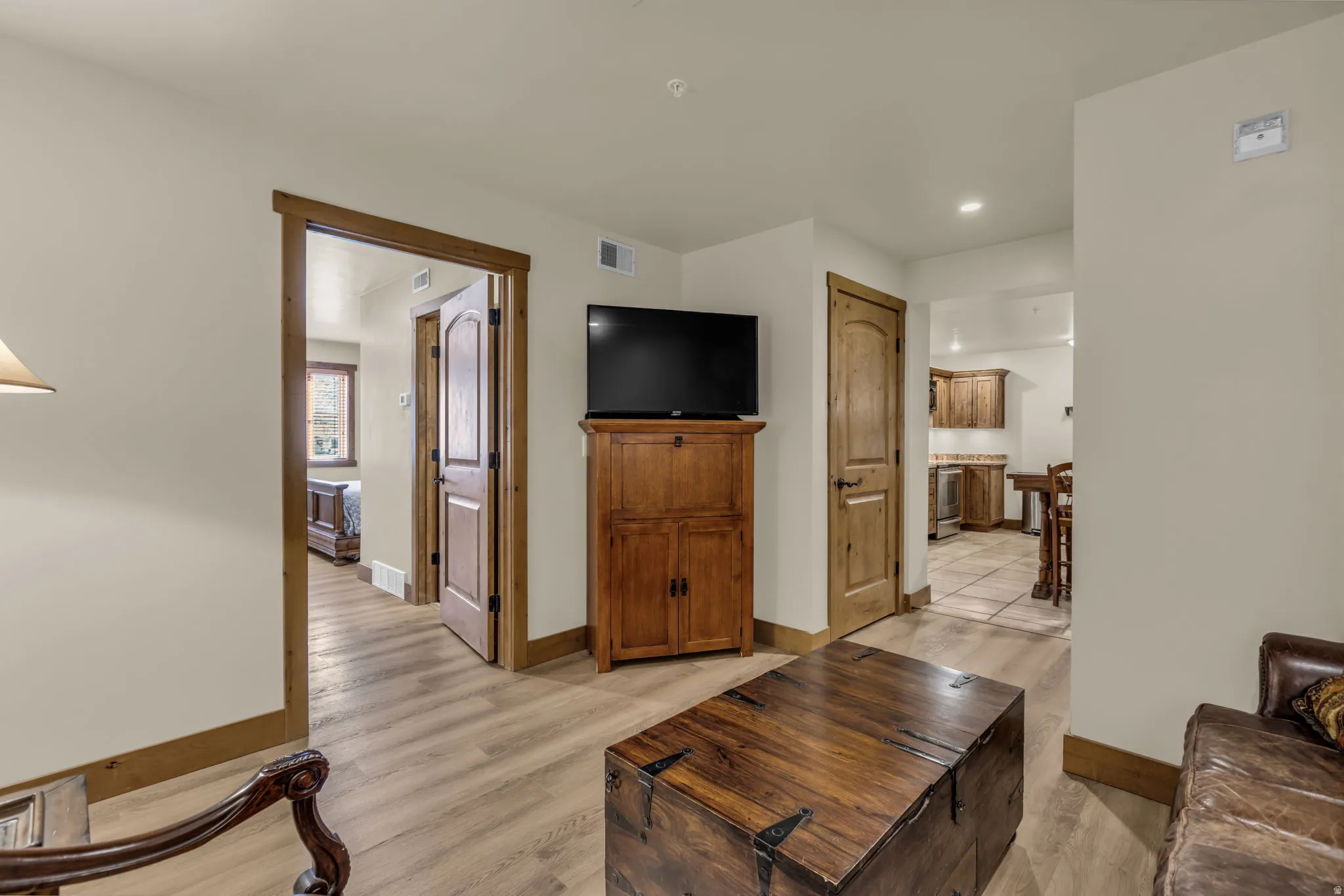 Living room with light wood-type flooring and recessed lighting