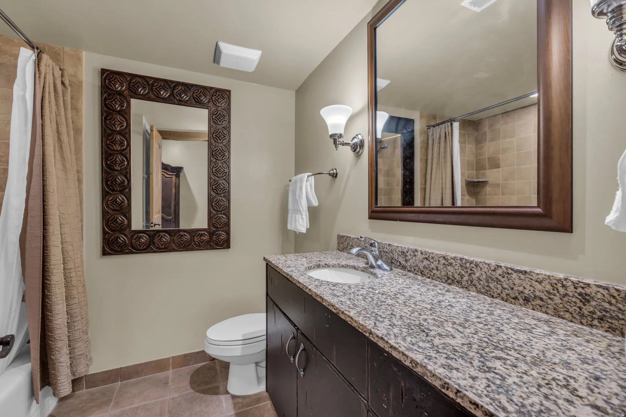 Full bath with vanity, light tile patterned flooring, and shower / bathtub combination with curtain