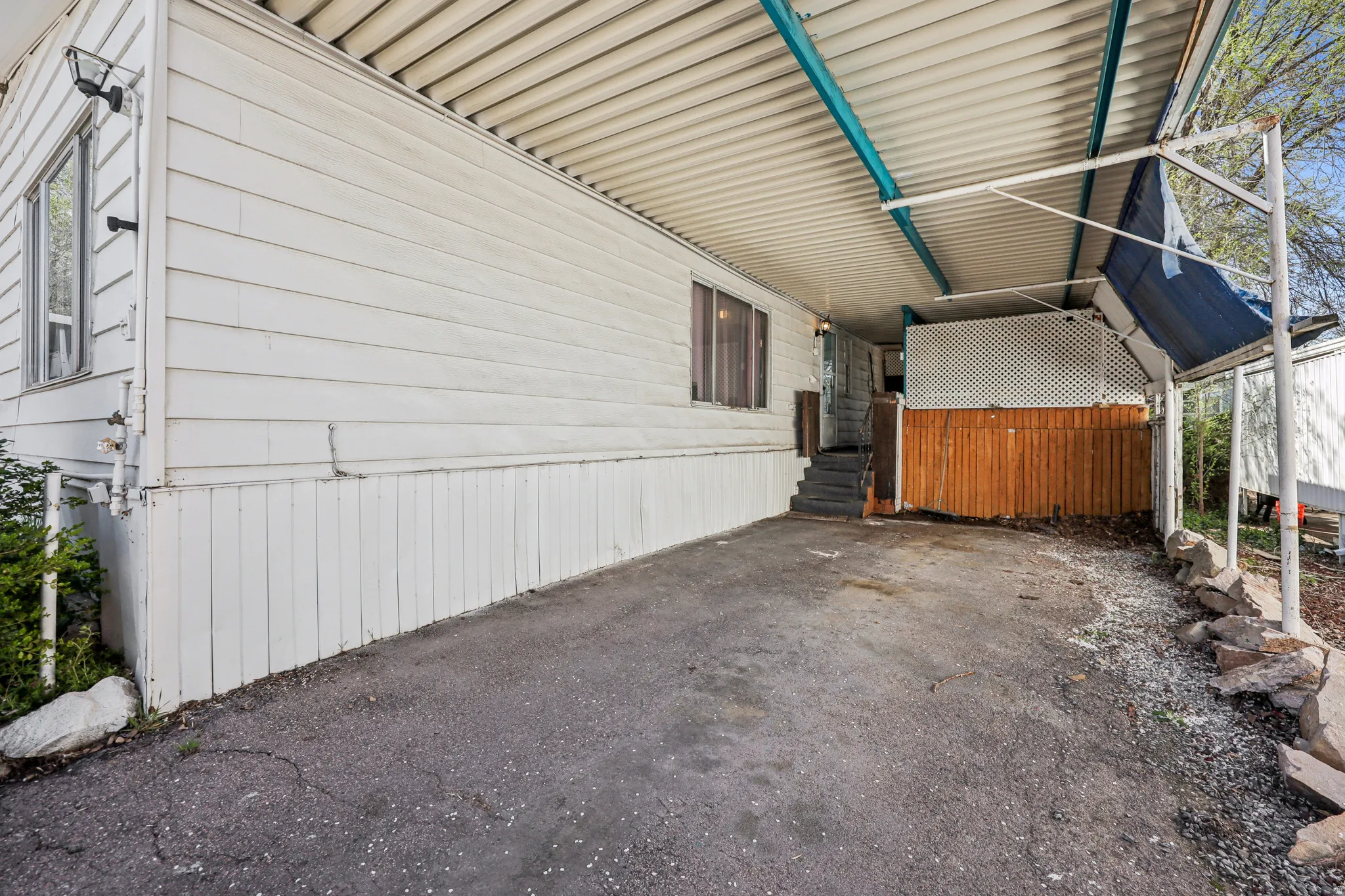 View of side of home featuring an attached carport