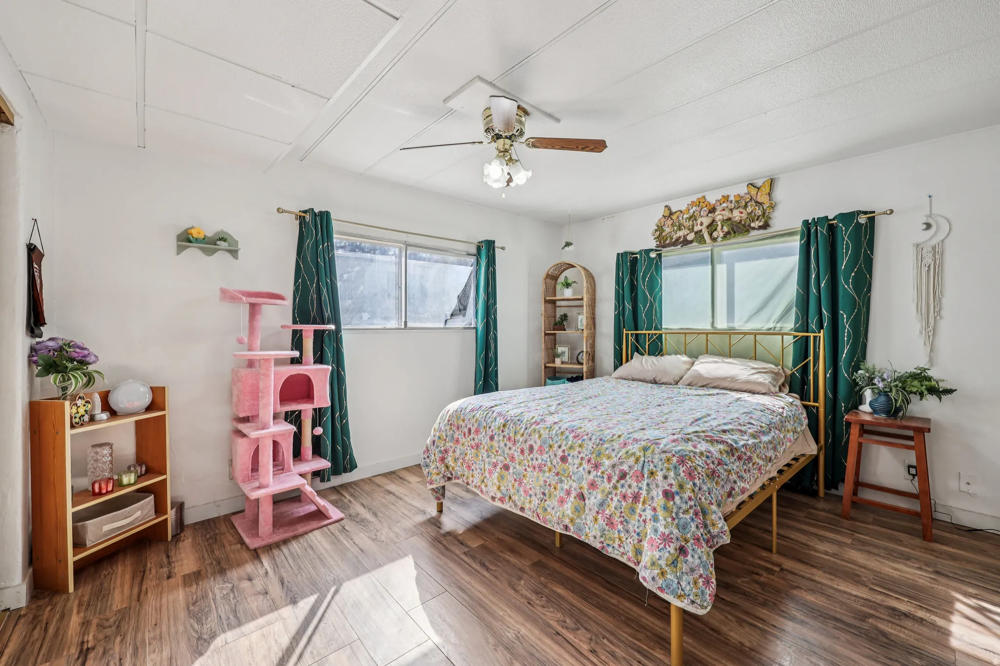 Bedroom featuring wood finished floors and a ceiling fan
