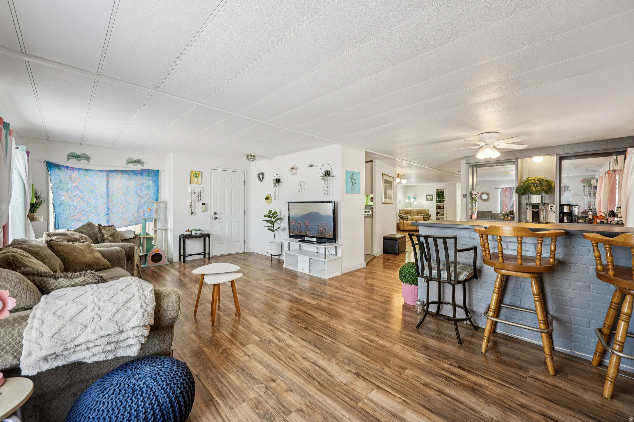 Living room featuring wood finished floors and a ceiling fan