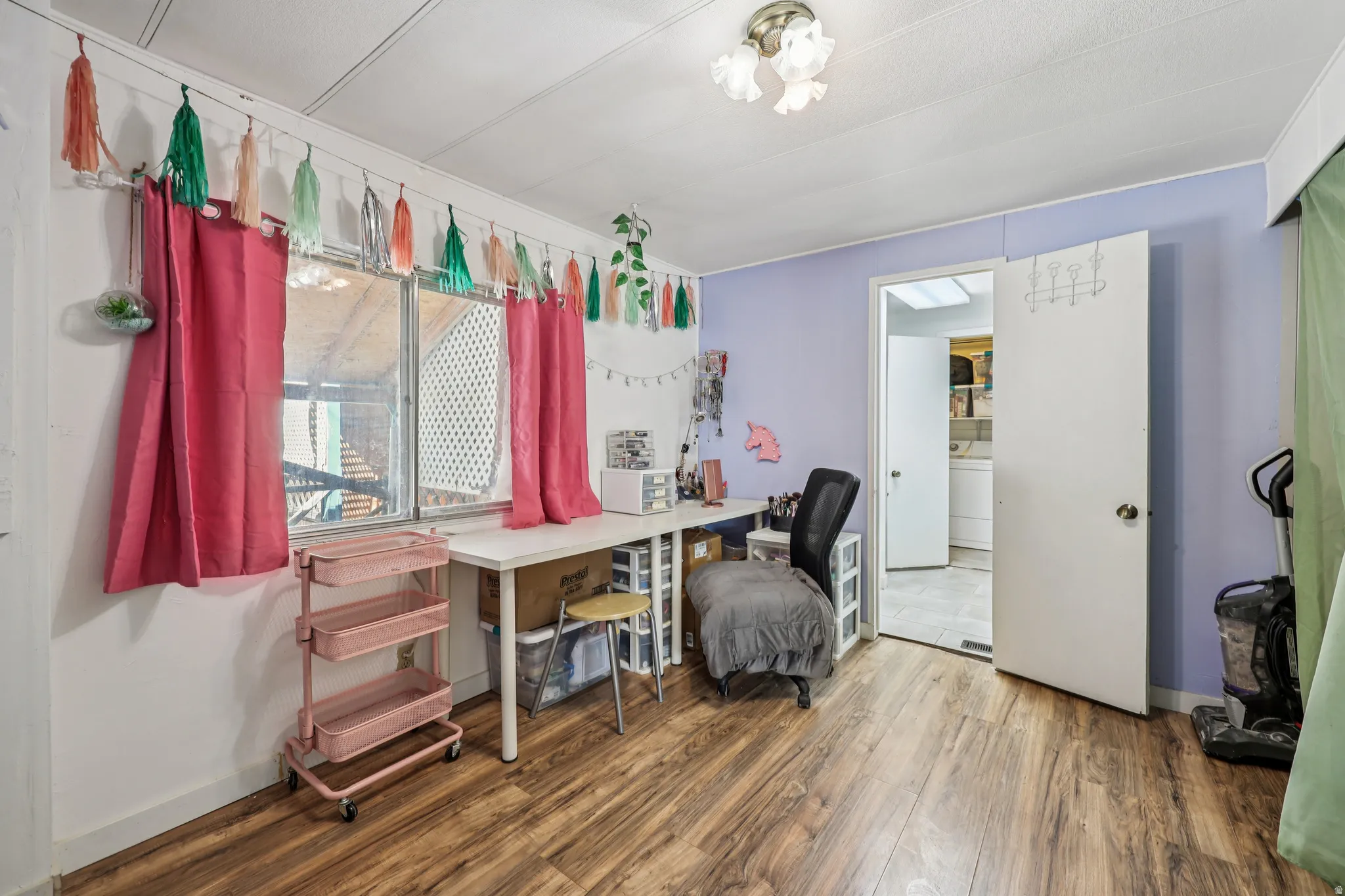 Office space featuring dark wood-style flooring and washer / clothes dryer