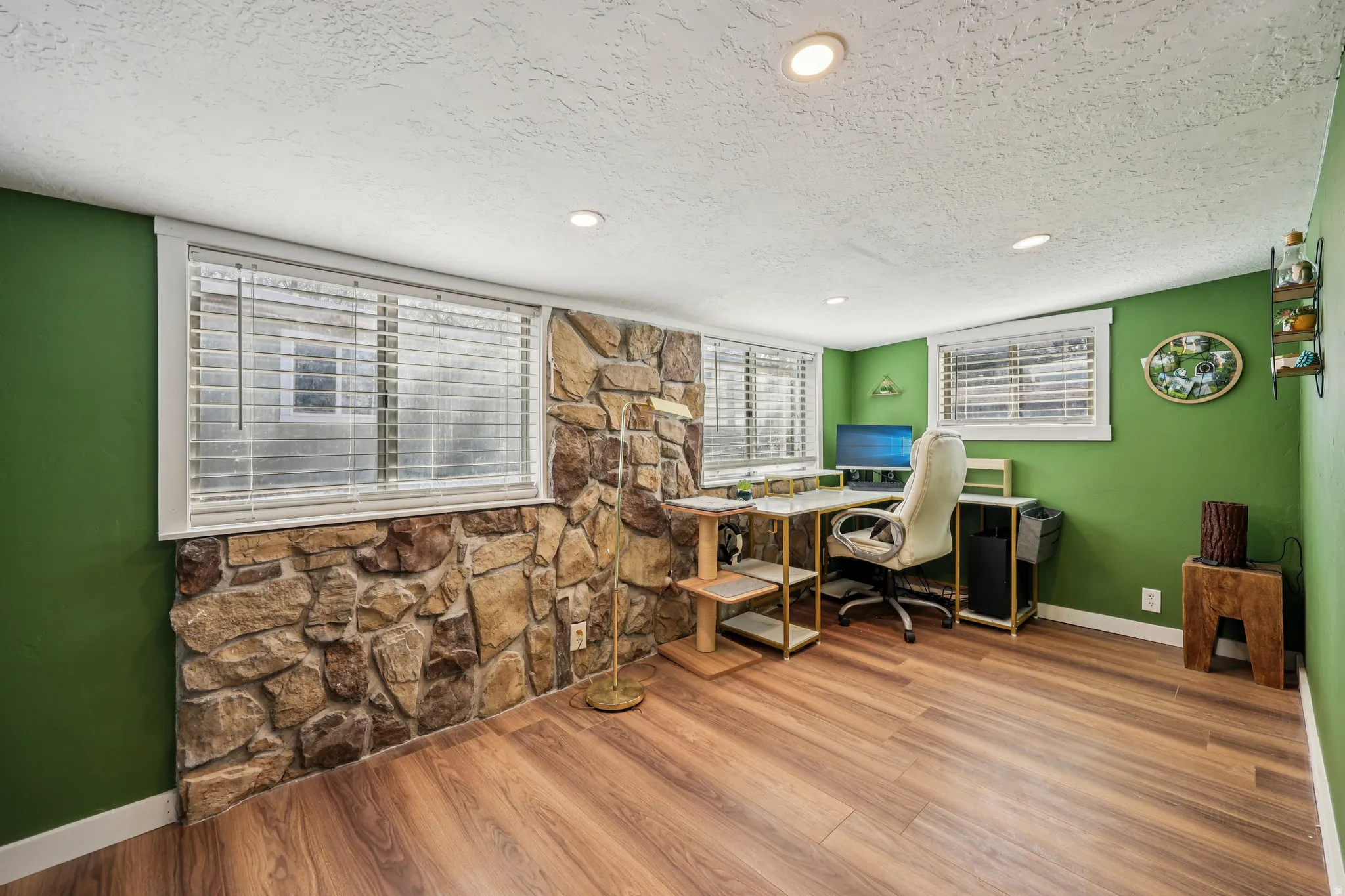 Office area with a textured ceiling, light wood-type flooring, and recessed lighting